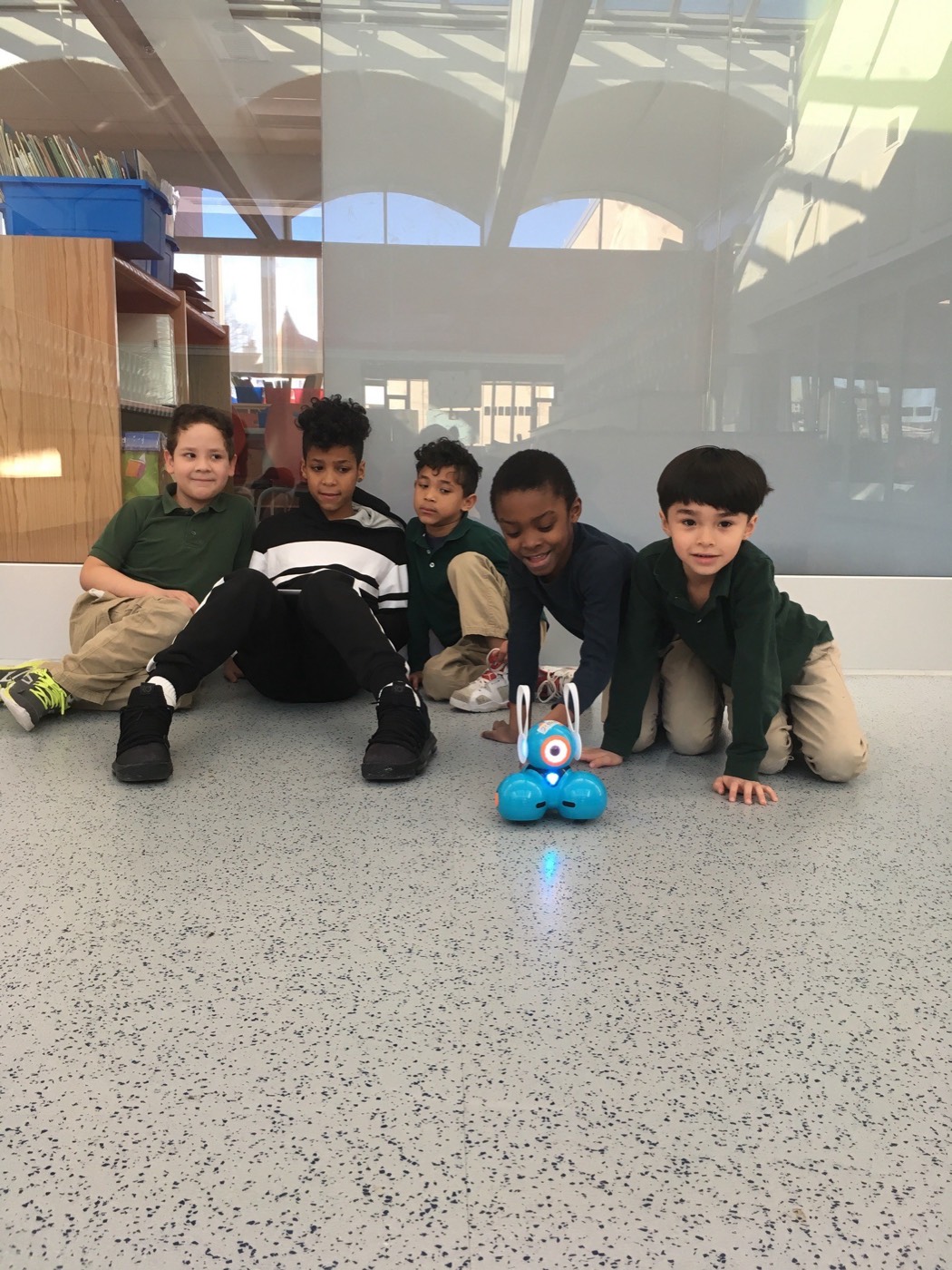 A group of students working with a robotics toy