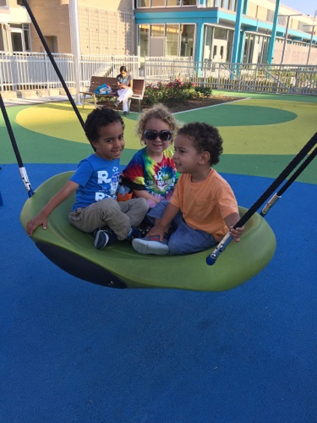 Children playing together on a swing on the playground